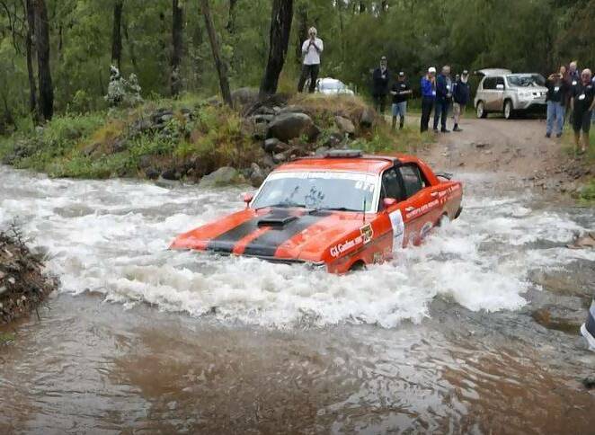 WHAT A BLAST: Shoalhaven trio Noel Kennedy, Al Spencer and Peter Flanagan cross a creek in Victoria in the Ford Falcon GT1. Photo: Phil Torode