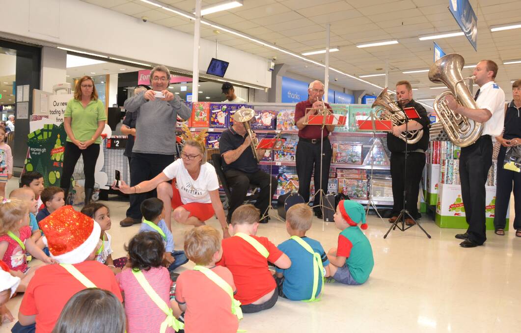 GREAT TIME: Children from Kids Korner child care centre listen to the Nowra Salvation Army band during Wednesday’s launch of the Nowra Kmart Wishing Tree Appeal.