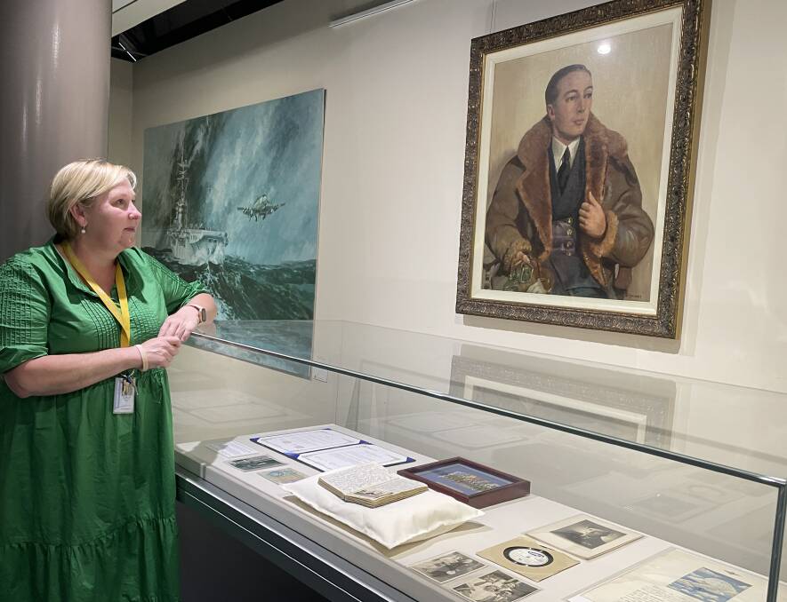 EXHIBITION: Acting Fleet Air Arm Museum manager and collection curator Ailsa Chittick with the exhibition marking the 70th anniversary of the death of Lieutenant Keith Clarkson, Australia's first Fleet Air Arm member to be killed in action.