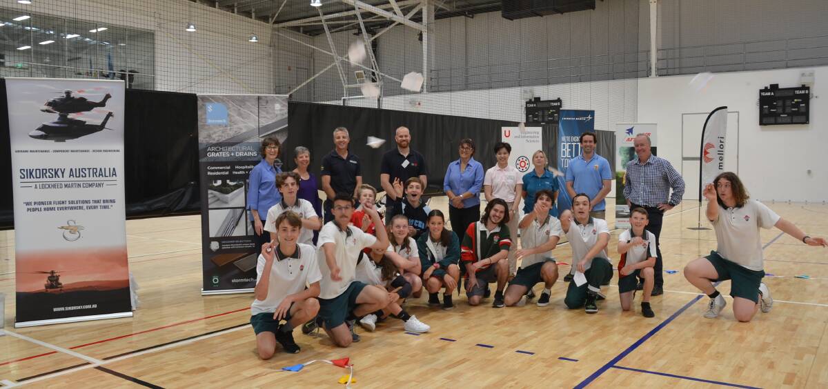 KEEN COMPETITION: Representatives of Sikorsky Australia, the Nowra Show Society, Global Defence, Regional Development Australia Far South Coast and University of Wollongong Shoalhaven Industry 4.0 Hub with Bomaderry High students during their competition at the Shoalhaven Indoor Sports Centre.