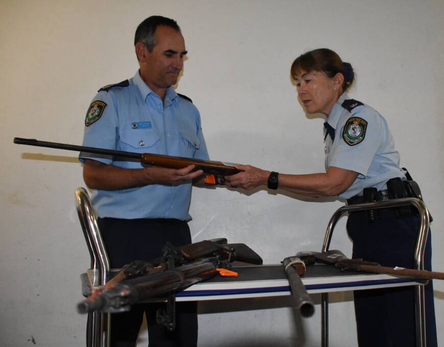 South Coast Police District exhibits officer at Nowra Police Station Senior Constable John White and Inspector Sue Charman-Horton with some of the guns handed in during the recent amnesty.