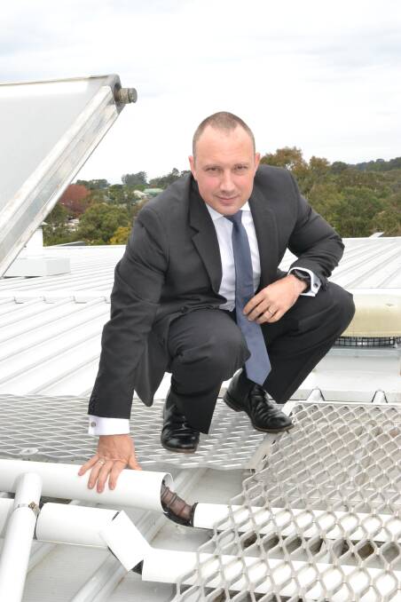 COSTLY EXERCISE: Quest Apartments Nowra franchisee James Blanchett with some of the lengths the company has gone to 'corella proof' its building.
