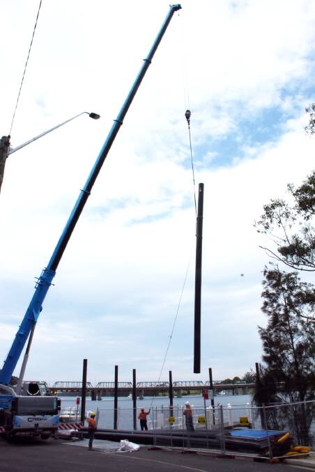 START: Workers from Bell Rock Marine from Port Macquarie undertake the initial pylon installation for the new Greys Beach jetty in the Shoalhaven River. 