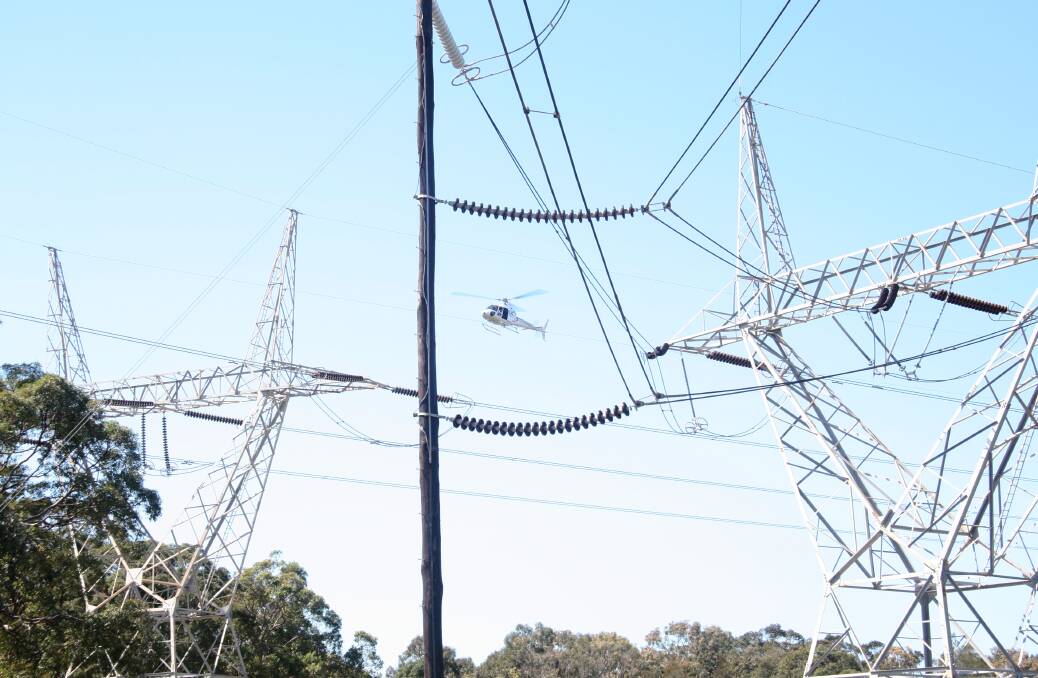 INSPECTION TIME: A TransGrid helicopter undertaking inspection of power lines.