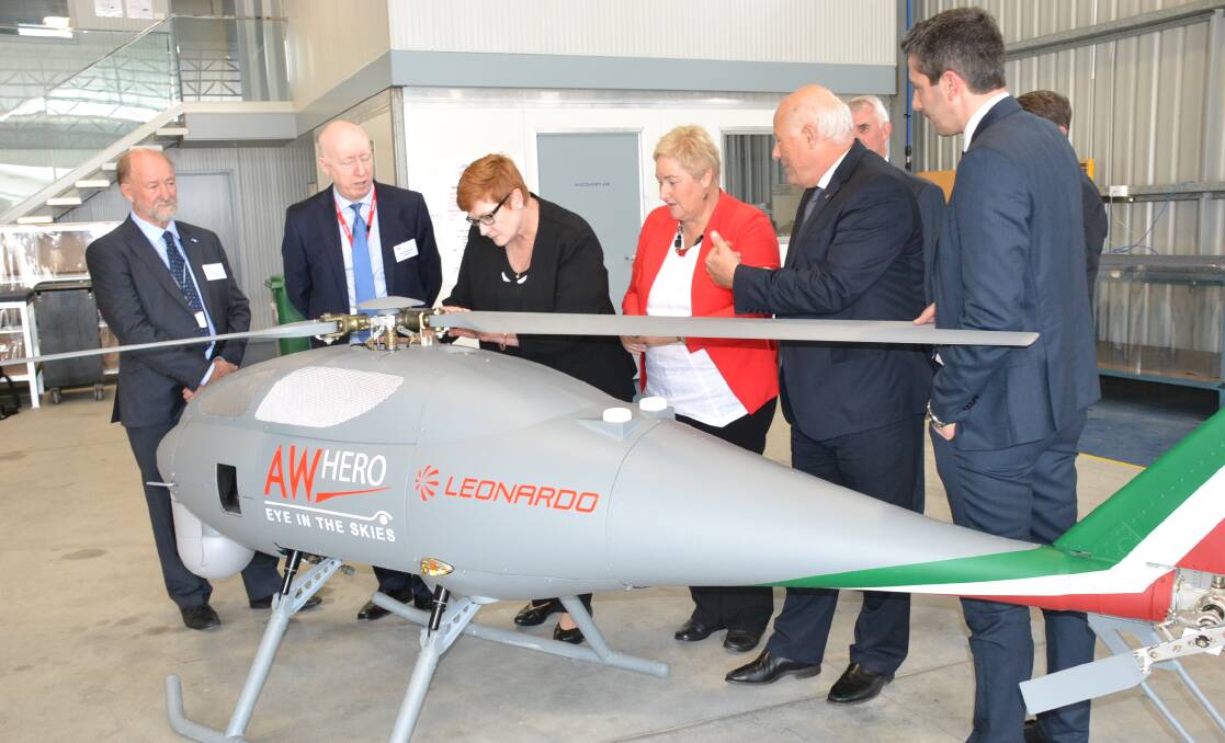 Minister for Defence Senator Marise Payne and Gilmore MP Ann Sudmalis look over the AgustaWestland Hero unmanned helicopter at Air Affairs with CEO Chris Sievers (far left) and  Leonardo Helicopters engineer Roberto Pretolani (far right).