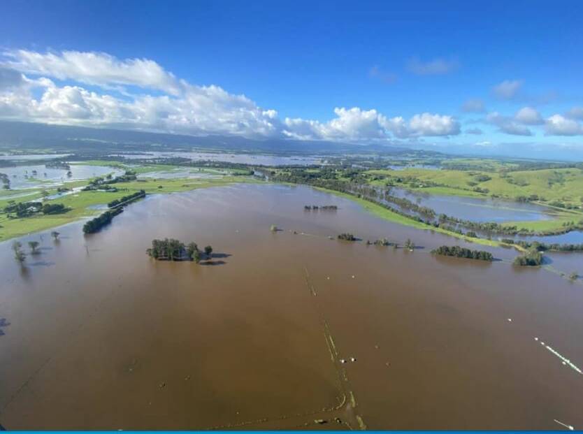 BROWN SEA: Floodwaters at Bolong, east of Bomaderry, looking north back over a flood-swollen Broughton Creek. Photo: Max Cochrane