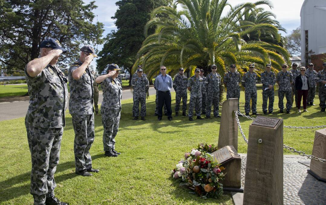LEST WE FORGET: Royal Australian Navy personnel salute the Sea King 'SHARK 02' helicopter accident memorial at HMAS Albatross. Photo: Ryan Tascas
