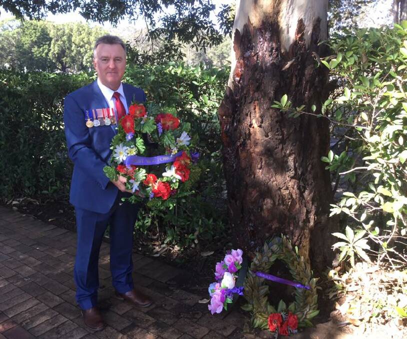 Keith Payne VC Veterans Benefit Group chairman Rick Meehan lays a wreath at the Nowra War Cemetery.
