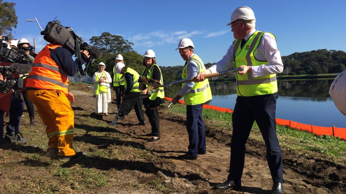 GETTING THAT SHOT: Michael Pignataro covering the sod turning of the new $434 million Nowra bridge - of course, right in the middle of the action. Nice high-vis by the way!
