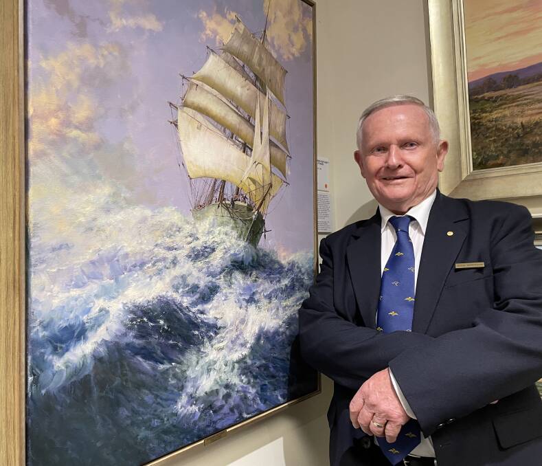 FAVOURITE: Renown Shoalhaven artist John Downton with his favorite work at his latest exhibition, a Celebration of John Downton at the Fleet Air Arm Museum at HMAS Albatross, of the square rigger Rona, in heavy Tasman Seas.