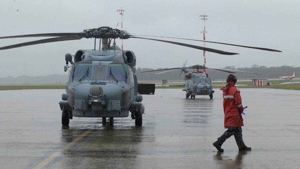 ACTION STATIONS: An Aviation Support sailor conducts checks with an MH-60R Romeo helicopter from 816 Squadron at HMAS Albatross. Photo: Susan Mossop