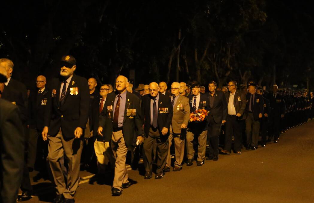 Veterans march in the Greenwell Point Anzac Day dawn service.