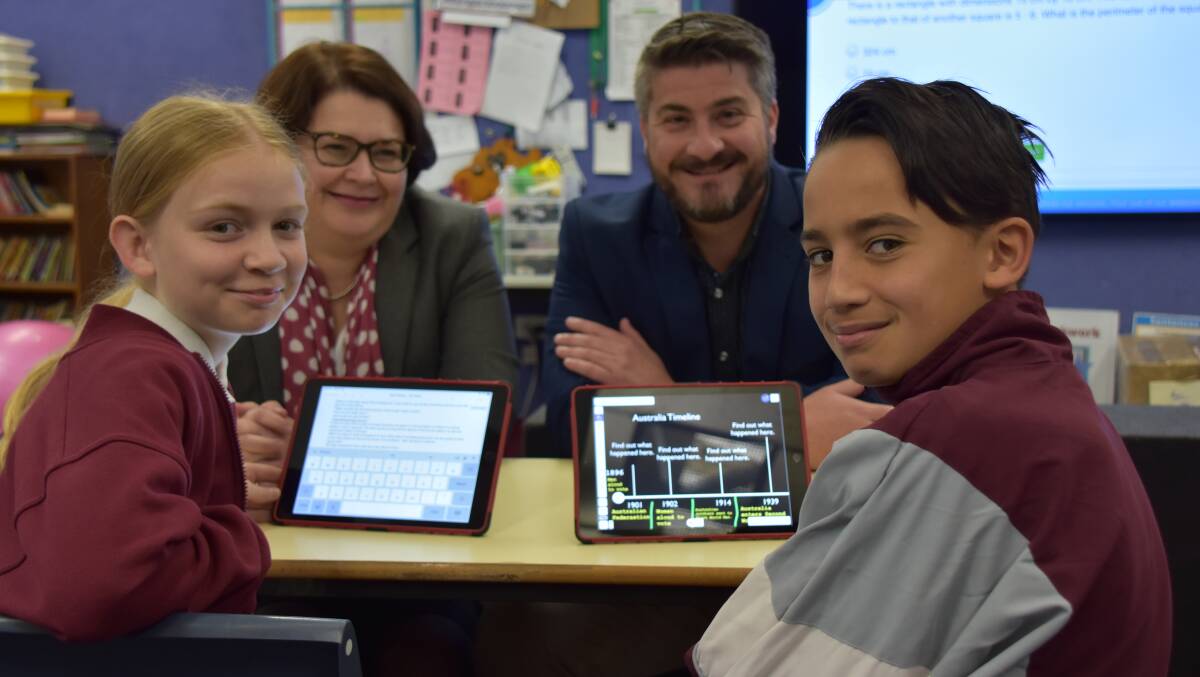 NEW SKILLS: Nowra Public principal Nicole Humphreys and deputy principal Brad Tate with year 6 students Tanaya Eade and Jayden Russell about to launch into work on their iPads.
