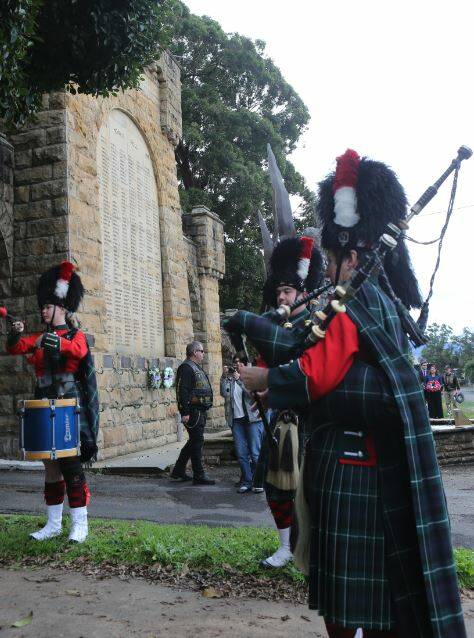MOVING: Shoalhaven City Pipes and Drums Pipe Major, Kim von Prott,(right) leads the band playing Battle O'er to mark the 75th anniversary of VP Day in Nowra.
