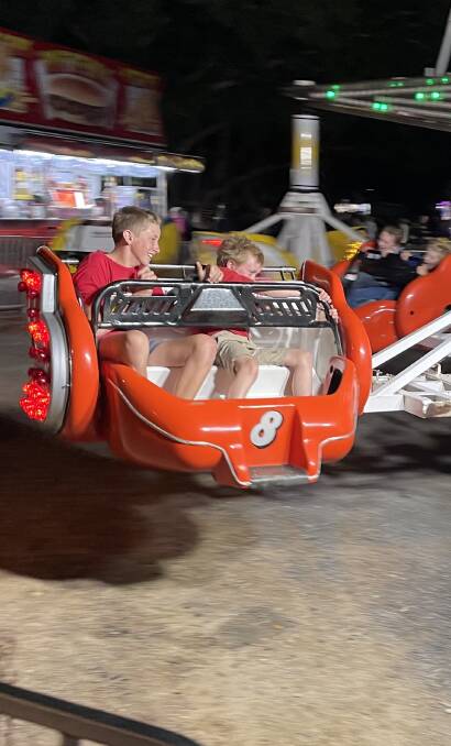 HANG ON TIGHT: Dusty and Cody Cochrane take to one of the Nowra Show rides.
