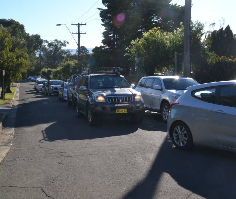 WAIT: The waiting line for testing at Nowras drive-through COVID testing clinic, stretching down Collins Way.