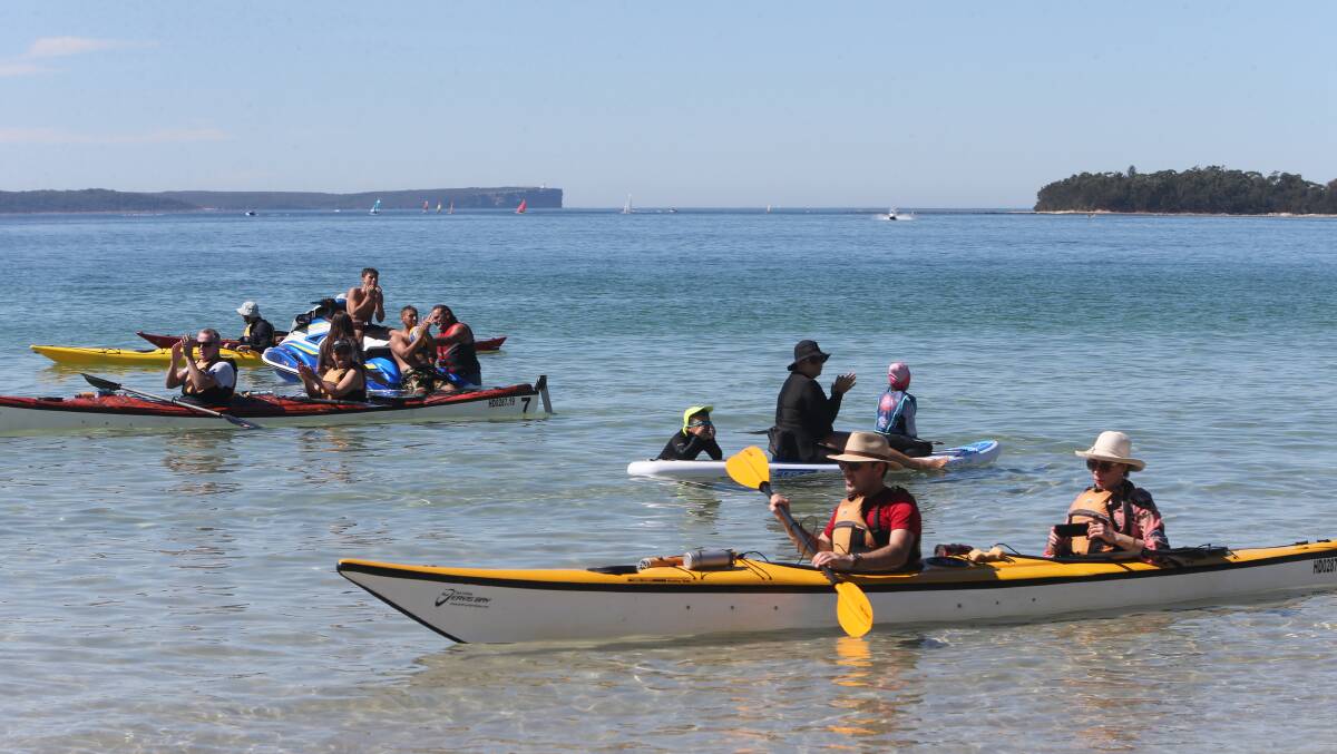 RESPECT: Sea kayakers even stopped in the waters of Jervis Bay to pay respect.

