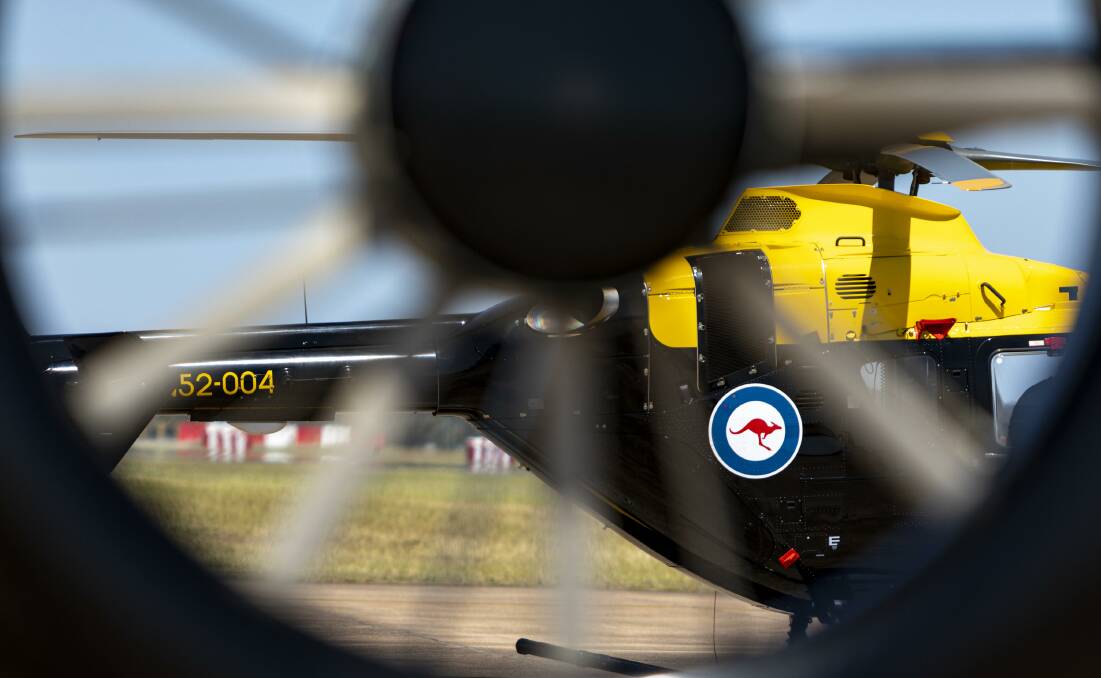 
A Royal Australian Navy EC-135 helicopter on the flight line at Royal Australian Air Force Base Williamtown, Newcastle, on standby to support the firefighting efforts. Photo: Leo Baumgartner