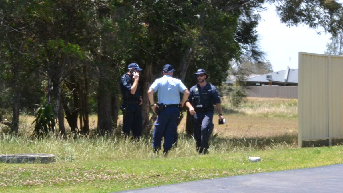 A number of the South Coast Police officers at the scene of the suspicious fire at Worrigee on Tuesday.

