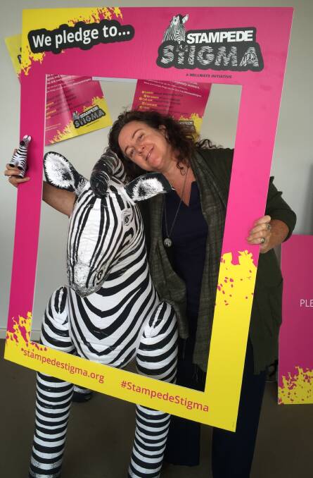 LOGO: Wellways practical support worker Jo Gallary with one of the Stampede Stigma logos, a yet to be named zebra.