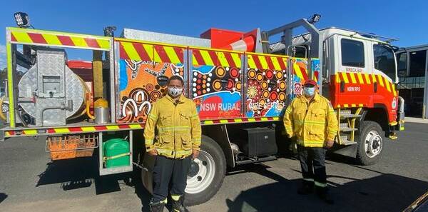 NEW LOOK: Wreck Bay RFS Captain Anthony AJ Roberts and Deputy Captain Bernie McLeod with Wreck Bay 1 and the newly installed indigenous artwork.