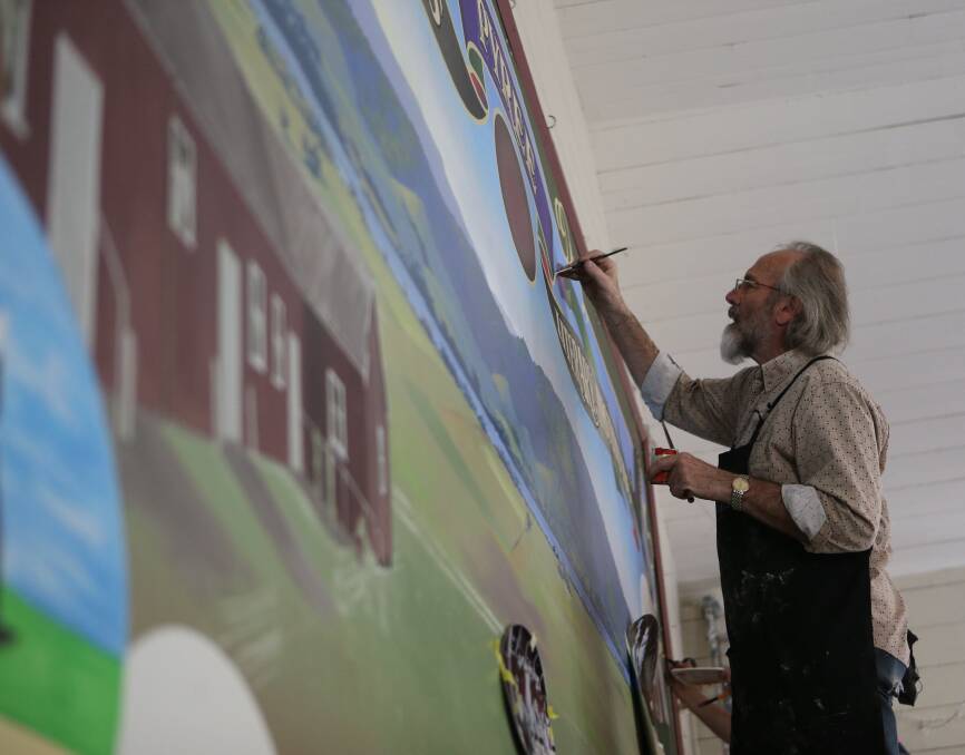 Local sign writer Phil Constantine, of Falls Creek works on the giant mural at Pyree Literary Institute as part of the Letterheads' 25th anniversary weekend.