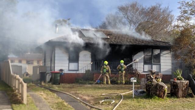 Fire and Rescue NSW crews ensure the North Nowra house fire is out. Photo: Stuart Thomson