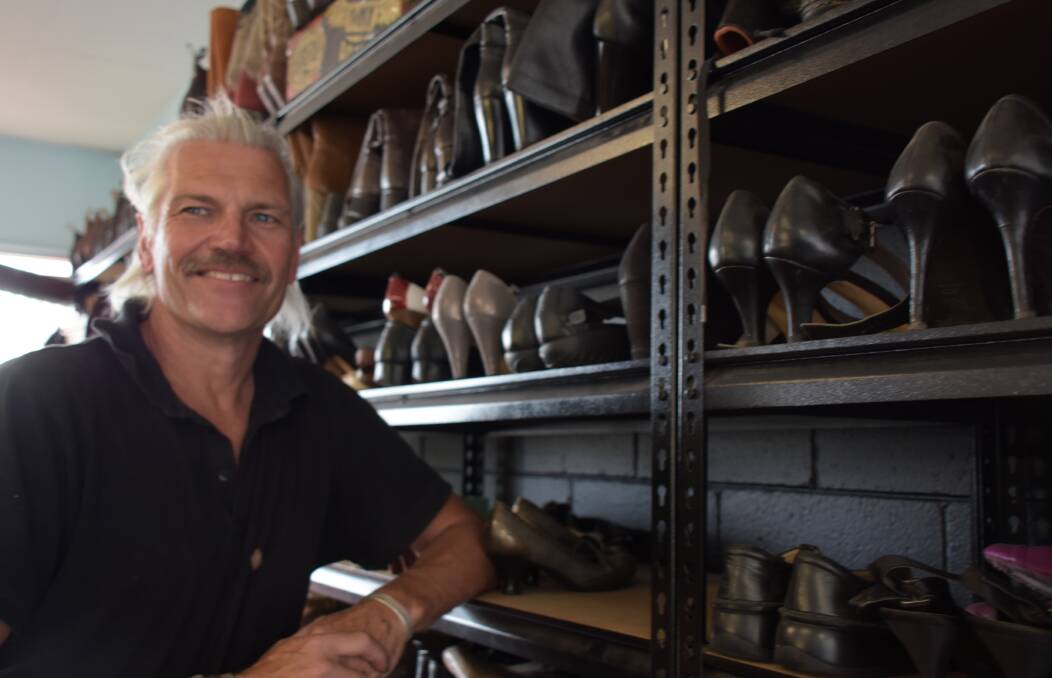 THE WALL OF SHOES: John's Shoe Repairs owner Jan van Arkel with his wall of work.