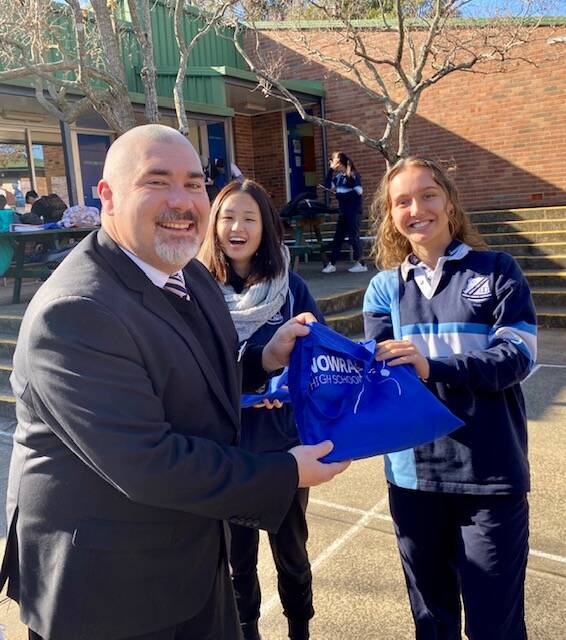 GOOD LUCK: Nowra High principal Glen Kingsley presents Tenzin Nyidon and school captain Jessica O'Donnell with HSC survival kits. Photos: Supplied