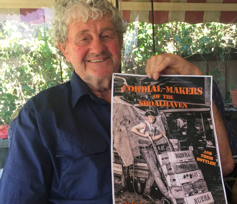 MYSTERY: Bomaderry's Ron Smith with the cover of Alan Clark's latest book, Cordial-makers of the Shoalhaven and their bottles.