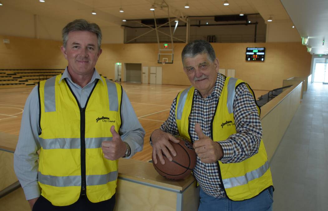 ON TARGET: Shoalhaven City Council's Shoalhaven Indoor Sports Centre project manager Gary George (left) with local basketball legend John Martin and the show court centre piece that has been named in his honour.