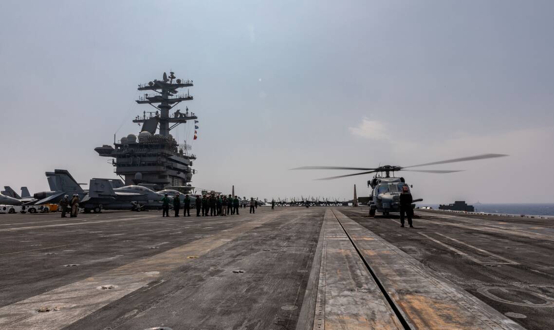 EXPERIENCE: 816 Squadrons MH-60R helicopter embarked on HMAS Ballarat conducts a cross deck landing on USS Nimitz during Indian Ocean Deployment 2020.Photo: Shane Cameron