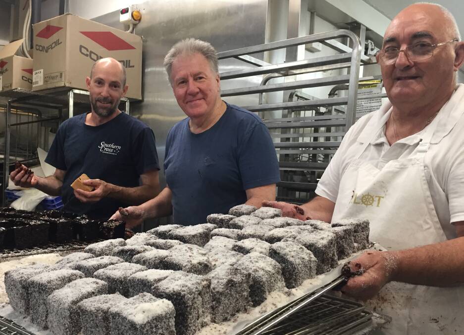 SUPPORT: Pete Satchell, Vic Leng and Garry Moon from the Bakehouse Delights team making some of the 1000 dozen lamingtons they hope to sell to support Harvey.