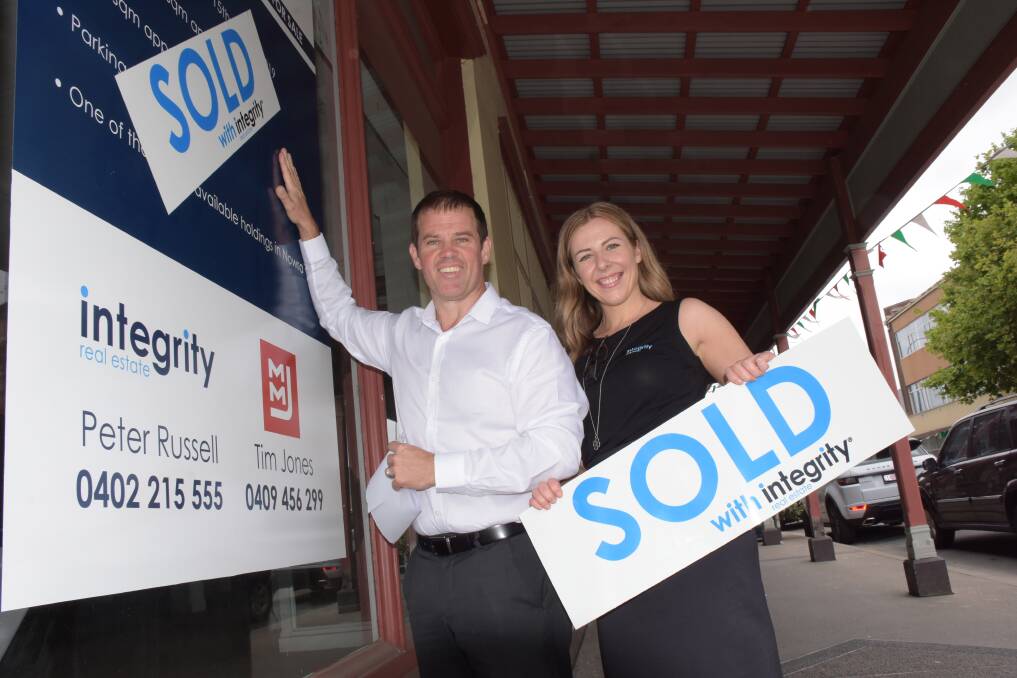 SOLD, SOLD, SOLD: Integrity director Peter Russell and head of the commercial division Bianca McMillan put the sold sign up on the former Nowra Spotlight building.
