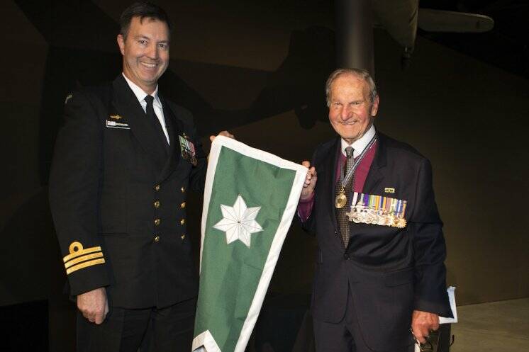  
Commanding Officer Flight 1, Rear Admiral Neil Ralph (right), presents the Unit Citation for Gallantry Burgee (pennant) to Commanding Officer 723 Squadron, Commander Bruce Willington, RAN, at the presentation of the Unit Citation held at the Australian War Memorial, Canberra. Photo: James McDougall 