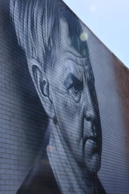 New Zealand’s Owen Dippie’s work of a gazing Arthur Boyd over Stewart Place on the back of Sturgiss Newsagency.
