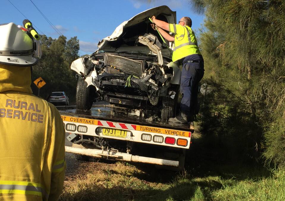 DAMAGE: Emergency services with the damaged vehicle after it was removed from Crookhaven River.