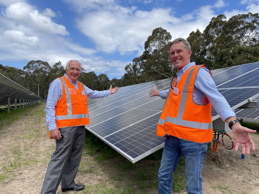 BIG DREAMS COMING TRUE: Shoalhaven Community Solar Farm construction convenor Bob Hayward (left) and Repower Shoalhaven chair Walter Moore with some of the 8000 solar panels which will be commissioned in mid-December.