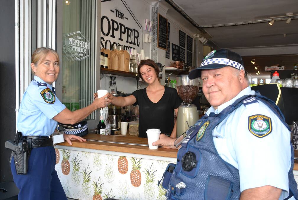CHEERS: Shoalhaven LAC Inspector Susan Charman-Horton and Shoalhaven crime prevention officer Senior Constable Anthony Jory grab a coffee from Zoe Holman from The Hopper Society ahead of next Thursday’s Coffee with a Cop.