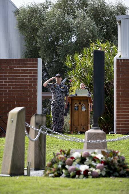 HONOUR: Commander of the Fleet Air Arm, Commodore Dave Frost, salutes during the Sea King 'SHARK 02' helicopter accident memorial ceremony at HMAS Albatross. Photo: Ryan Tascas