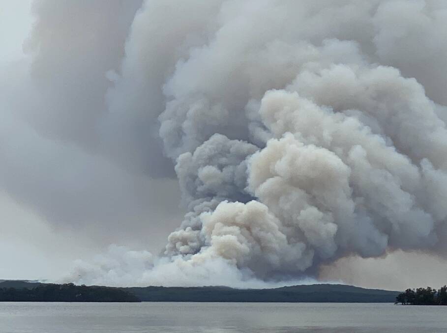 ANGRY MONSTER: John Wardle's incredible photo of the bushfire in the Booderee National Park at Jervis Bay, west of the fire from St Georges Basin looking east. 