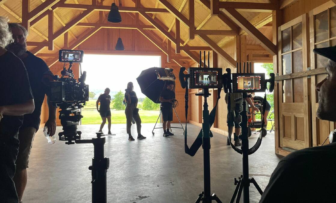 Inside the sweltering barn. Macario De Souza (far right) checks the angles of various camera's through small monitors. Picture: Desiree Savage