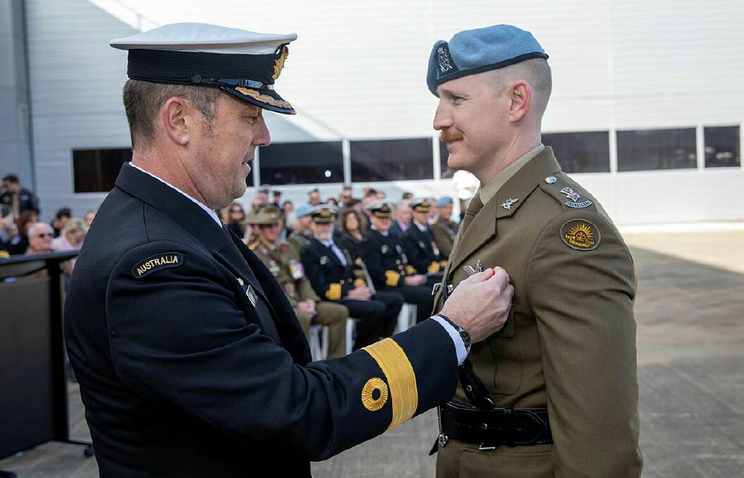 Commander Fleet Air Arm Commodore David Frost, left, presents Army Lieutenant Alex Powell with his 'Wings' at the 723 Squadron Graduation Ceremony held at HMAS Albatross in Nowra. Photo: Leading Seaman Ryan Tascas