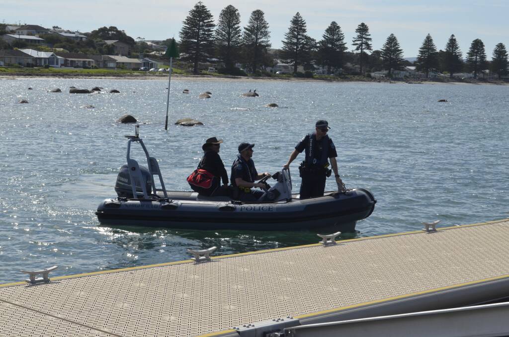 SAFE AND SOUND: SA Police deliver missing fisherman Derek Robinson back to his family at Victor Harbor. Photo The Times
