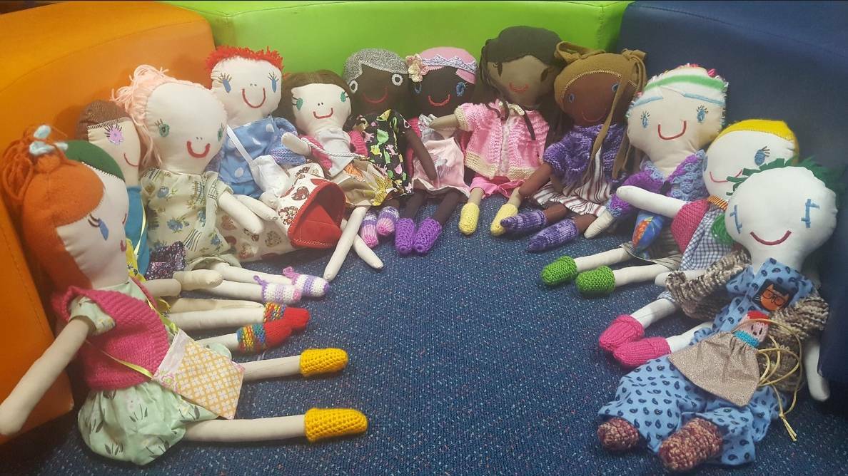 Children of the rebuilt Bobin Public school received hand made dolls from students at nearby Gloucester school to welcome them back after the fire.