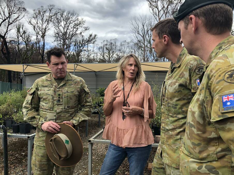 Eurobodalla Mayor Liz Innes at the shire's botanic garden in February talking with defence personnel about their work to repair the site. 