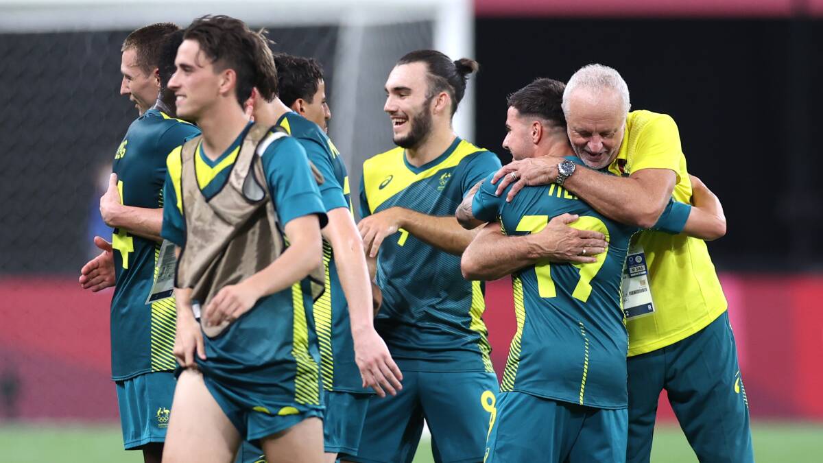 Marco Tilio embraces Australian coach Graham Arnold after scoring against Argentina on Thursday night. Photo: Masashi Hara
