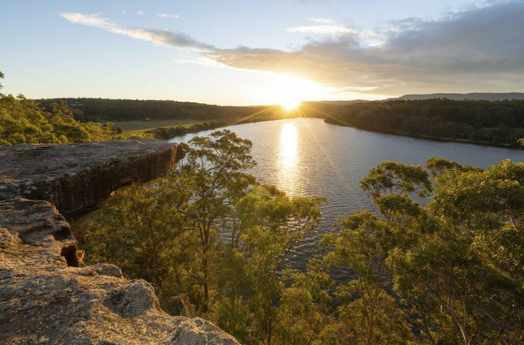The sun sets over Hanging Rock Lookout above the Shoalhaven River. Picture Destination NSW