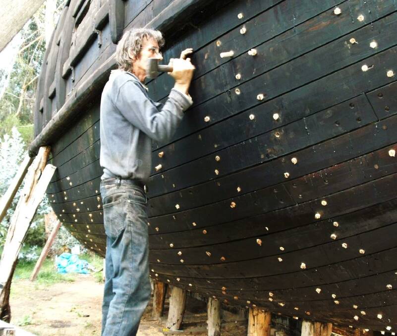 Graeme Wylie fastening some of the more than 3000 tree nails used in the vessel's hull planking during construction at Bushfield, Victoria, in a picture taken mid-2010. Picture: supplied 
