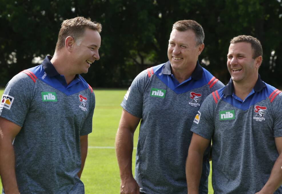 Knights coach Adam O'Brien shares a laugh with his assistants David Furner and Willie Peters. Photo: Simone De Peak.